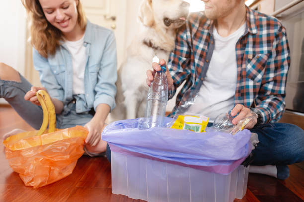 istock charming girl and cute guy share garbage waste 1204839791