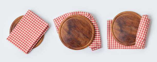 istock Round pizza board with red checked tablecloth collection on white background. Cooking or baking mock up for design. Top view from above 1204841086