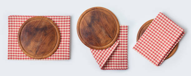 istock Round pizza board with red checked tablecloth collection on white background. Cooking or baking mock up for design. Top view from above 1204841096