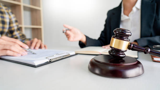 istock Midsection Of Lawyer Guiding Businessman While Sitting At Office 1204847110