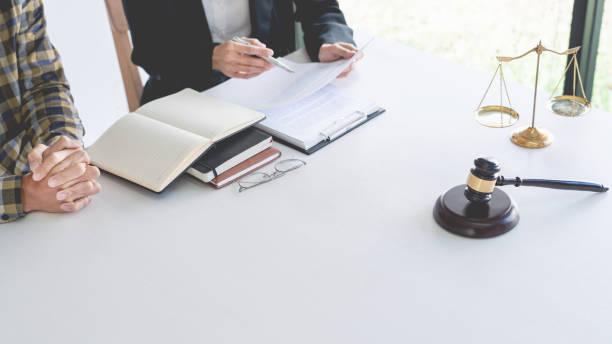 istock Midsection Of Judge With Client Discussing On Table 1204847123