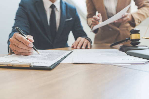 istock Midsection Of Judge With Lawyer Working On Table 1204847141