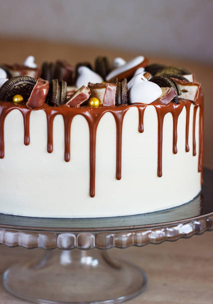 Male, Stylish, Modern Chocolate Cake with Fudge Drizzled Icing on White Backdrop
