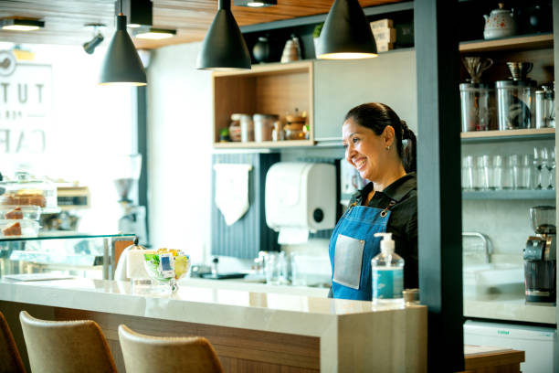 istock Woman working in a coffee shop and smiling 1204847562