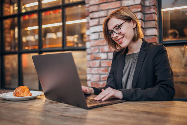 istock Pretty woman is working on laptop 1204852890