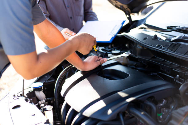 istock Cropped Hand Of Mechanic Using Dipstick In Car Engine 1204854419