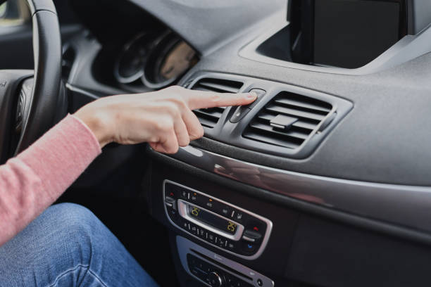 istock Midsection Of Woman Pressing Push Button In Car 1204854811