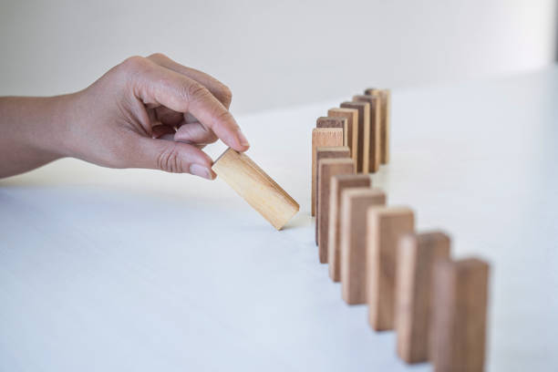 istock Cropped Hand Arranging Wooden Block Over White Background 1204855161