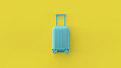 Blue luggage bag, cabin baggage on yellow background, traveling summer concept. Stylish vacation suitcase, pastel colors, summertime tourist background with space for text. Tourism conceptual design.