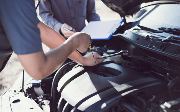 istock Cropped Hand Of Mechanic Using Dipstick In Car Engine 1204856241