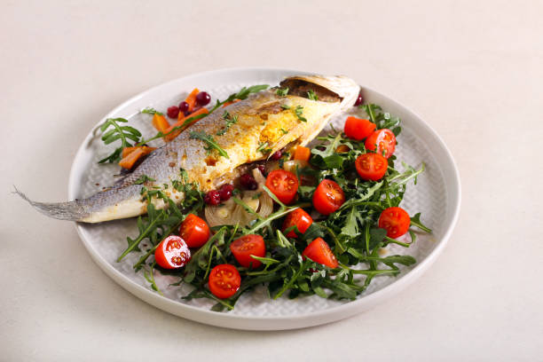 istock Salad with baked sea bass fish 1204856283
