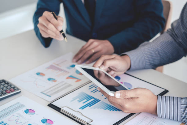istock Midsection Of Business People Using Digital Tablet Working On Table In Office 1204856415