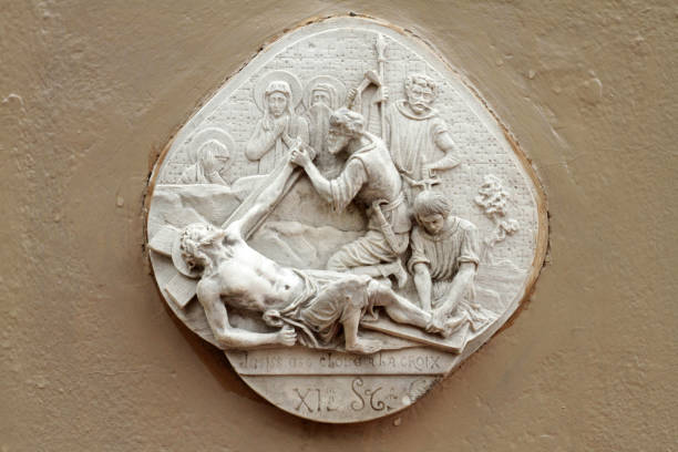 wall sculpture representing station 11 of a way of the cross: jesus christ is nailed to the cross. cathedral of our lady of mercy. cotonou. benin. west africa. - our lady of africa imagens e fotografias de stock