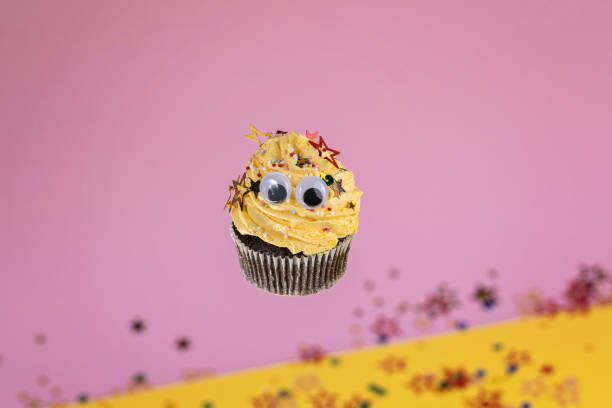 istock Funny flying chocolate cupcake with cheerful plastic eyes 1204858086