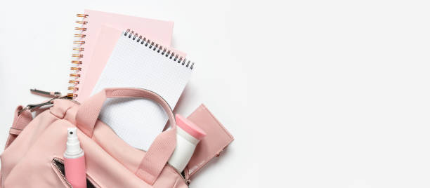 istock Flat lay, Women's accessories pink backpack, glider, water bottle and spray for the face on a white background, trend things girl generation z, fashion background banner 1204858146