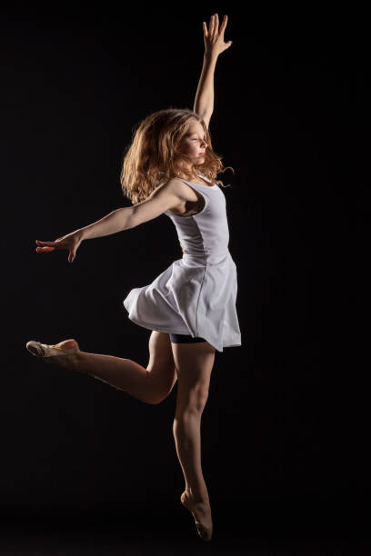 istock Dancer in dress on black background 1204858188