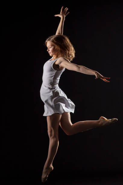 istock Dancer in dress on black background 1204858199