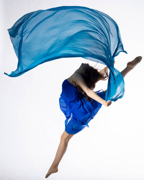 istock Dancer in dress with blue fabric on white background 1204858265