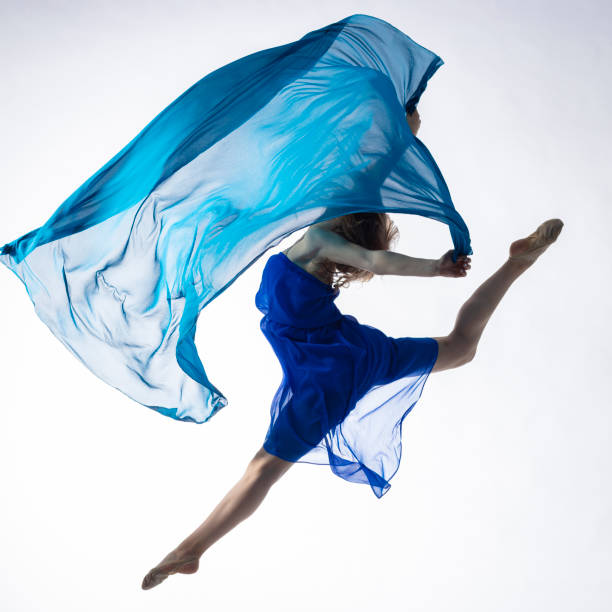 istock Dancer in dress with blue fabric on white background 1204858278