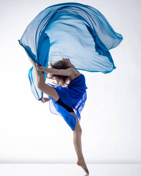 istock Dancer in dress with blue fabric on white background 1204858280