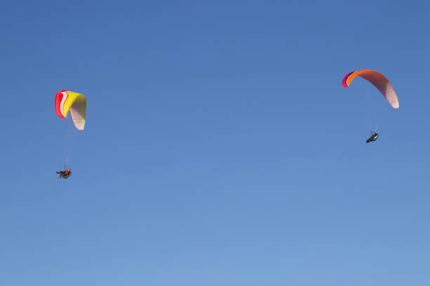 istock Two paragliders in mid-air. 1204858850