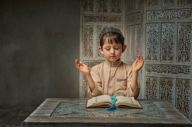 istock Muslim boy praying to Allah, ramadan celebration concept 1204858952