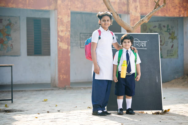 istock Brother and sister in school uniform 1204860376