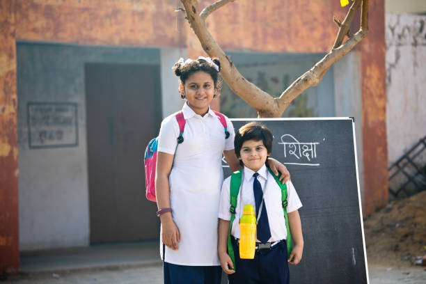 istock Brother and sister in school uniform 1204860405