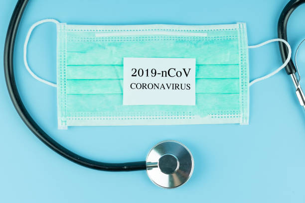 istock Protective face mask and Stethoscope on blue background, against Novel coronavirus (2019-nCoV) or COVID-19 and Influenza. Antiseptic, Hygiene and Healthcare concept 1204864193