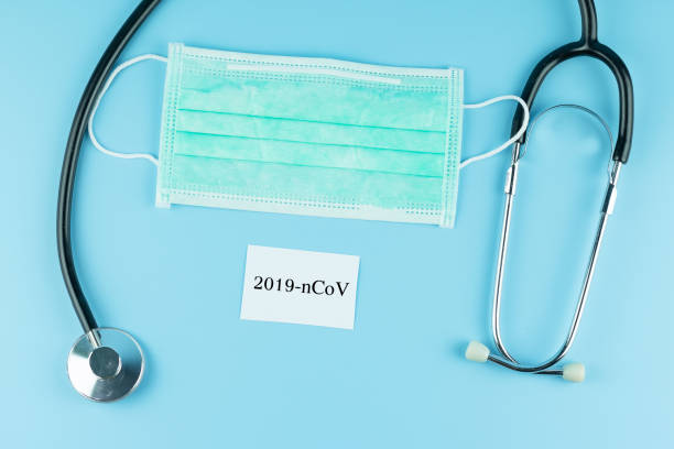 istock Protective face mask and Stethoscope on blue background, against Novel coronavirus (2019-nCoV) or COVID-19 and Influenza. Antiseptic, Hygiene and Healthcare concept 1204864197