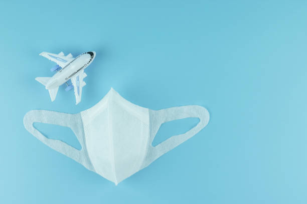 istock Protective face mask and airplane model on blue background, against Novel coronavirus (2019-nCoV) or COVID-19 and Influenza. Antiseptic, Hygiene and Healthcare concept 1204865390