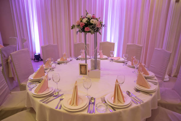 Luxury wedding table decoration. Chairs are around the table.Special event table set up. Fresh flower decoration. Pastel colors.