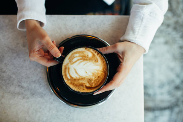 istock Woman drinking latte at cafe 1204871885