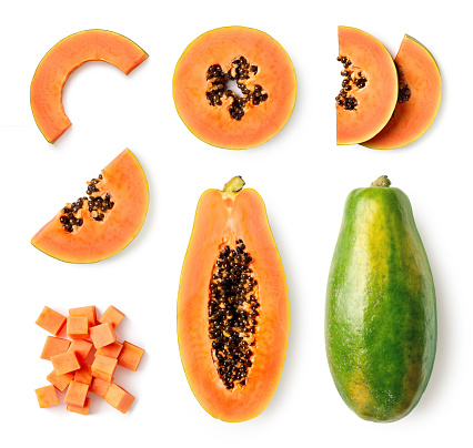 Set of fresh whole and half papaya fruit and slices isolated on white background, top view