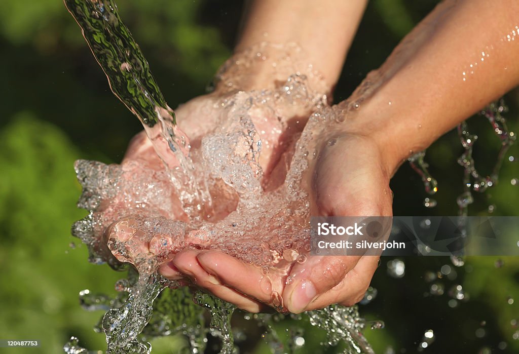 Manos de mujer con salpicaduras de agua - Foto de stock de Agua potable libre de derechos