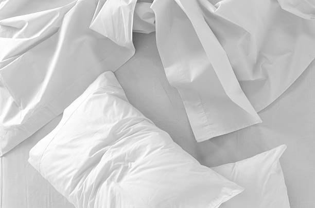 istock Background of a messy white bed with white pillows 120487853