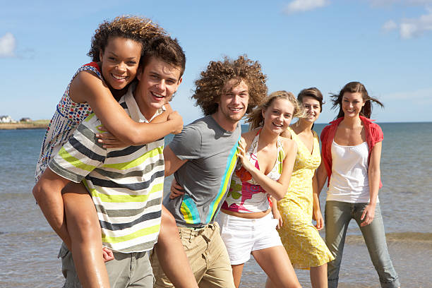 istock Young Friends Walking Along Summer Shoreline 120487974