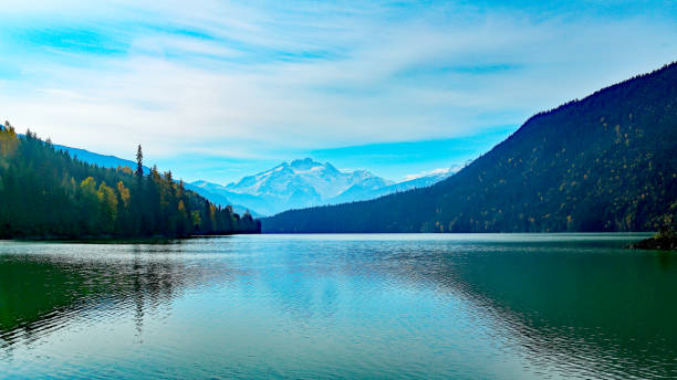 istock Lake with green water, mountains and sky 1204884955