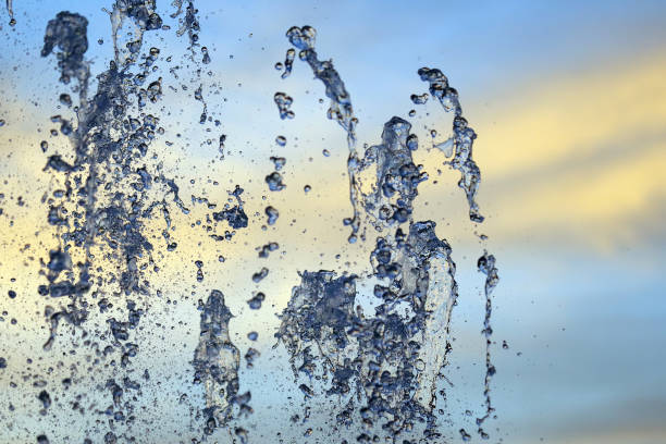 istock Drops of a falling water fountain against the evening sky. natural textures and backgrounds 1204885708