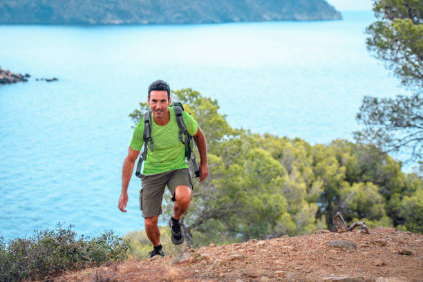 Active Mature Spanish Male Hiking Up Coastal Trail