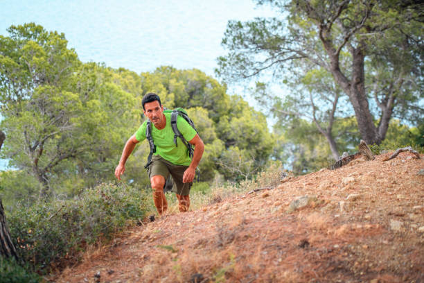istock Strong Spanish Male Backpacker Climbing Up Trail 1204887663