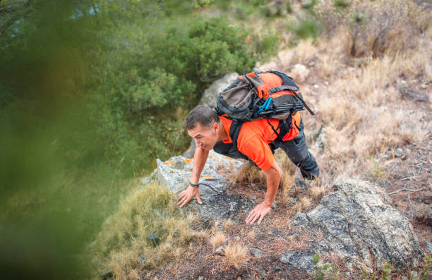 istock Mature Spanish Male Hiker Climbing Rocky Hillside 1204887666
