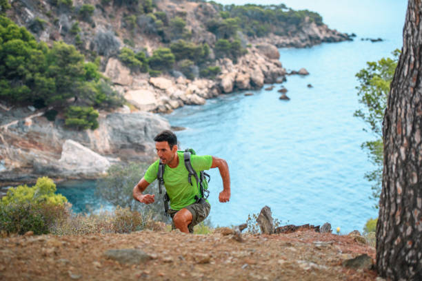 istock Fit Spanish Male Hiker Climbing Cliffside Trail 1204887709