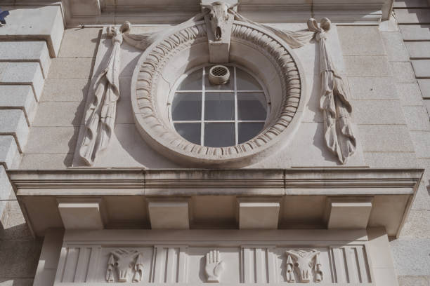 Buenos Aires, Argentina - November 9, 2019: Two women using their smartphones to shoot through round window during guided tour to public building in the weekend long event Open House. It is held once a year and provides free access to buildings not normally opened to the public. It promotes architecture and heritage sites to a wider audience, being an opportunity to discover hidden architectural gems and to see behind doors places that are rarely open to the public