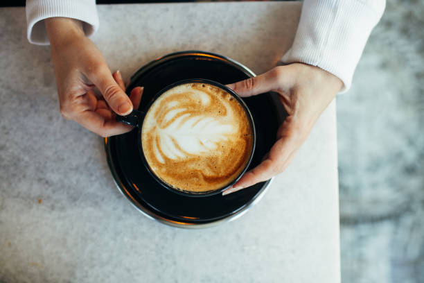 istock Woman drinking latte at cafe 1204887922