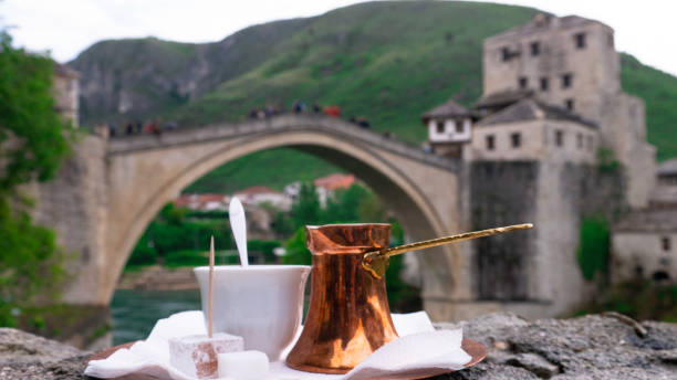 Traditional Turkish coffee and a view of Mostar Old bridge, Bosnia And Herzegovina. Traditional Turkish coffee in front of Old bridge in Mostar. Traditional Turkish coffee and a view of Mostar Old bridge, Bosnia And Herzegovina. Traditional Turkish coffee in front of Old bridge in Mostar. mostar stock pictures, royalty-free photos & images