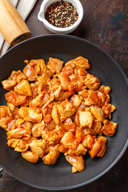 istock Chicken fillet cut into small pieces for frying in pan 1204889545