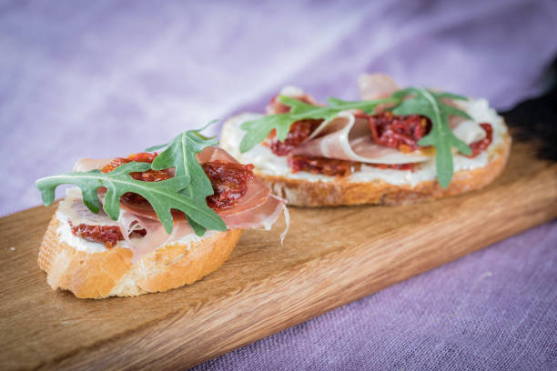 istock Bruschetta with tomato and basil, bruscetta with salmon and eggs, bruscetta with prosceutto and rucola 1204889720