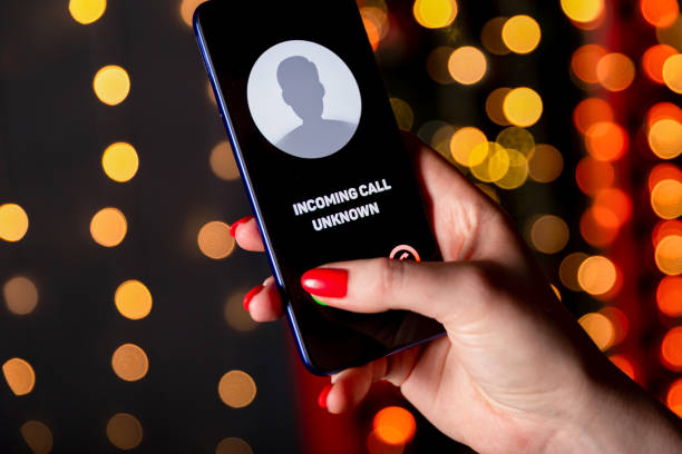 Phone call from unknown number. Scam, fraud or phishing with smartphone concept. Prank caller, scammer or stranger. Woman answering to incoming call. Hoax person with fake identity