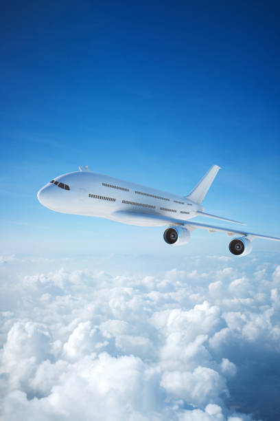 istock White passenger aircraft flying over clouds 1204891250